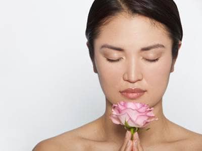 Asian woman praying pink rose