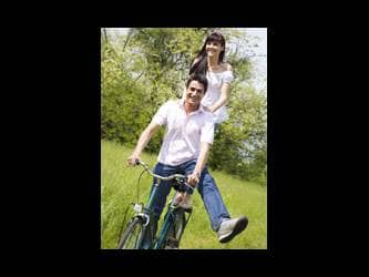 couple riding bicycle having fun