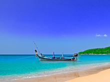 Boat on a coastal island beach against a blue sky