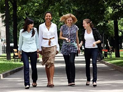 Four friends walking in a park