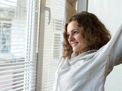 Woman waking up looking out window